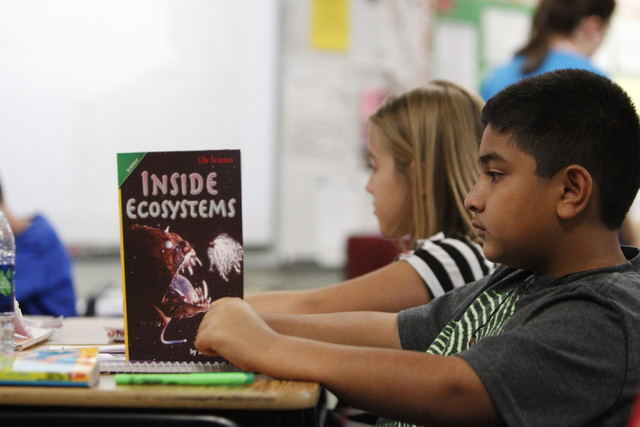 Fifth grader Keyaan Qureshi, 10, reads a books inside his classroom at Wright Elementary School in Las Vegas Friday, Sept. 19, 2014.  (Erik Verduzco/Las Vegas Review-Journal)