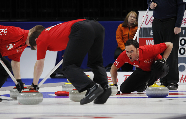 Team World's David Murdoch, far right, shouts instructions to his sweepers Greg Drummond, left, and Scott Andrews during the 2014 World Financial Group Continental Cup of Curling at the Orleans Ar ...