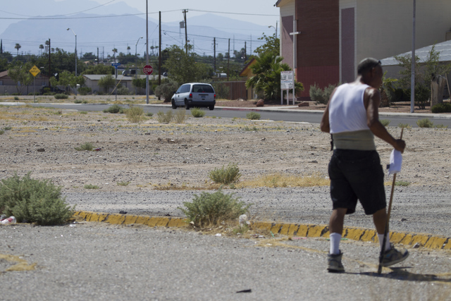A man walks on a dirt lot near Lake Mead Boulevard and Las Vegas Boulevard on Saturday, June 25, 2016, in North Las Vegas. Erik Verduzco/Las Vegas Review-Journal Follow @Erik_Verduzco