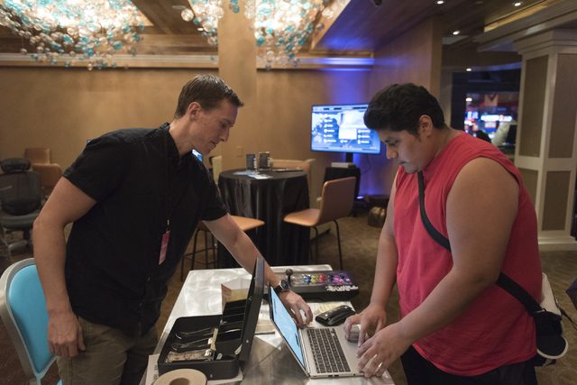 Angel Trejo, right, is registered for the Street Fighter V tournament by Kingsley Edwards, Leet co-founder, at the Downtown Underground e-sports lounge at Downtown Grand hotel-casino in Las Vegas ...