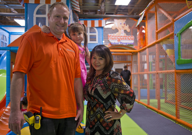 Owners Shawn and Mimi Wachter pose for a photograph with their daughter MaiLee inside their business, Kangamoo Indoor Playground, May 27, 2016. Daniel Clark/View