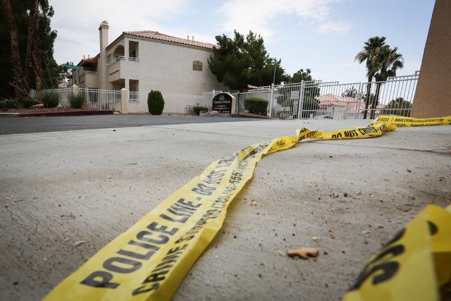 Crime scene tape lies on the ground near the entrance to Torrey Pines Condominiums, where part of a quadruple murder-suicide took place Wednesday night in Las Vegas on Thursday, June 30, 2016. Bre ...