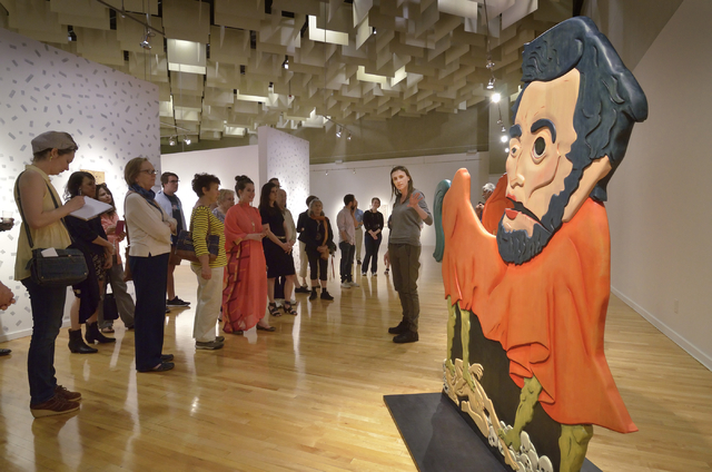 Former UNLV artist-in-residence Erin Cosgrove, right, discusses her "Urfather Lincoln" during the recent opening of "Five" at UNLV's Barrick Museum. Bill Hughes/Las Vegas Review-Journal
