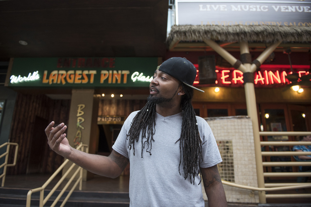 Las Vegas promotor Brandon Booker talks about enjoying the overcast rainy weather compared with record breaking-heat at the Fremont Street Experience in Las Vegas on Thursday, June 30, 2016. (Mart ...