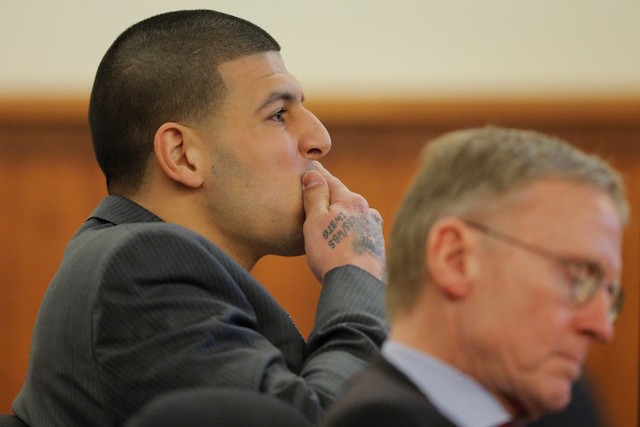 Former New England Patriots football player Aaron Hernandez and his attorney Charles Rankin listen as prosecution witness Alexander Bradley is questioned by the prosecution without the jury presen ...
