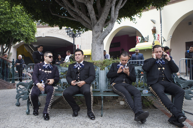 Members of Mariachi Tapio take a break after performs before a speech by Democratic presidential candidate Hillary Clinton during a campaign rally at Plaza Mexico on Monday, June 6, 2016, in Lynwo ...