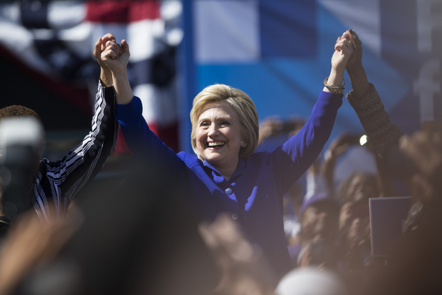 Democratic presidential candidate Hillary Clinton raises her arms at the end of her speech during a campaign rally at Leimert Park Village Plaza on Monday, June 6, 2016, in Los Angeles, Calif. Eri ...