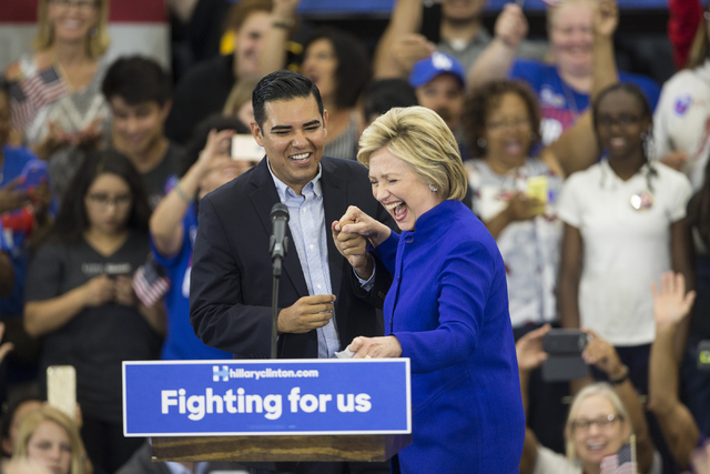 Long Beach Mayor Robert Garcia greets to the stage Democratic presidential candidate Hillary Clinton during a campaign rally at the Long Beach City College, Hall of Champions Gym on Monday, June 6 ...