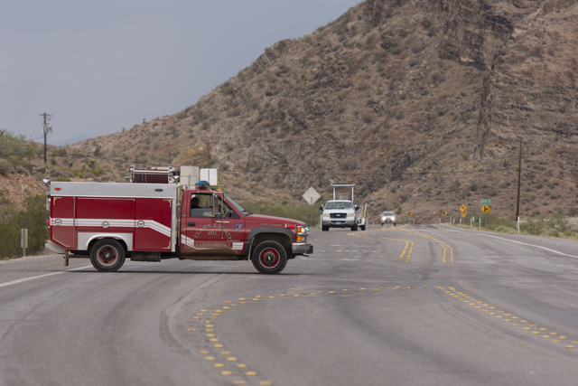 The Clark County Volunteer Fire Department turns aways traffic on state Route 159 just south of Bonnie Springs in Red Rock Canyon National Conservation Area due to a road washout Thursday, June 30 ...