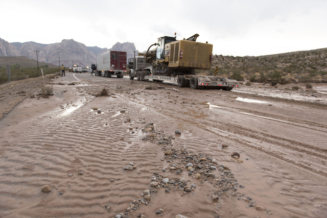 Crews on state Route 159 just south of Bonnie Springs in Red Rock Canyon National Conservation Area work to reopen the highway which was closed due to a washout Thursday, June 30, 2016. (Jason Ogu ...