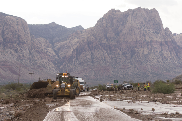 Crews on state Route 159 just south of Bonnie Springs in Red Rock Canyon National Conservation Area work to reopen the highway which was closed due to a washout Thursday, June 30, 2016. (Jason Ogu ...