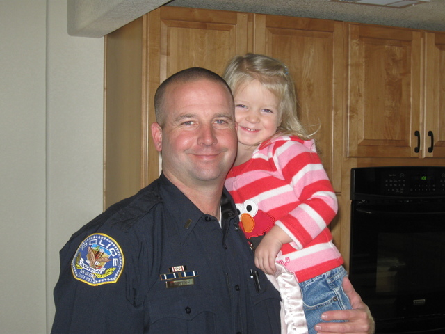 Dane Mattoon holds his daughter in an undated photo. Mattoon, a captain with the Henderson Police Department, discusses what it's like to be a father and a police officer. (Special to View)