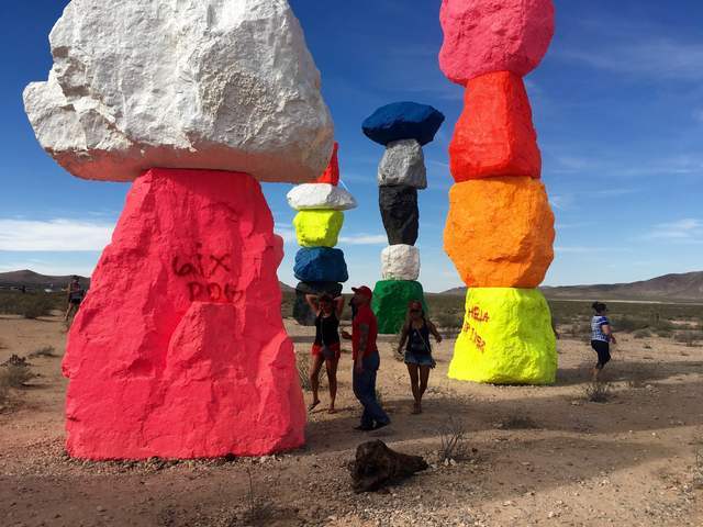People take pictures at the Seven Magic Mountains art project off Interstate 15. Vandals defaced several of the limestone boulders that make up the Seven Magic Mountains public land art project. ( ...