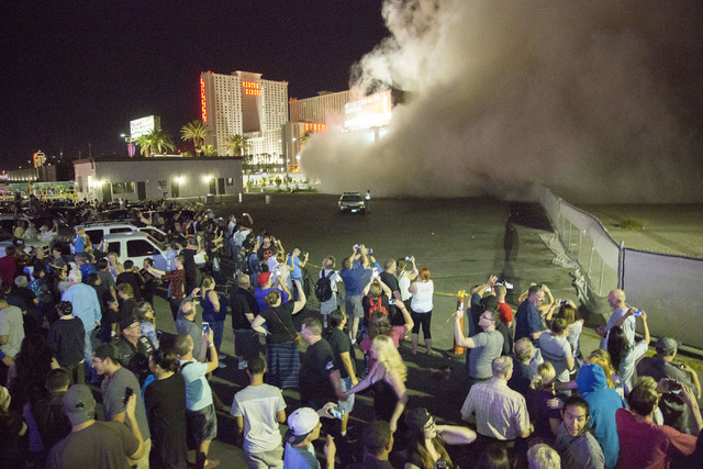 A cloud of dust from the imploded Monaco tower moves toward people at the Peppermill parking lot on Tuesday, June 14, 2016.  Jeff Scheid/Las Vegas Review-Journal Follow @jlscheid