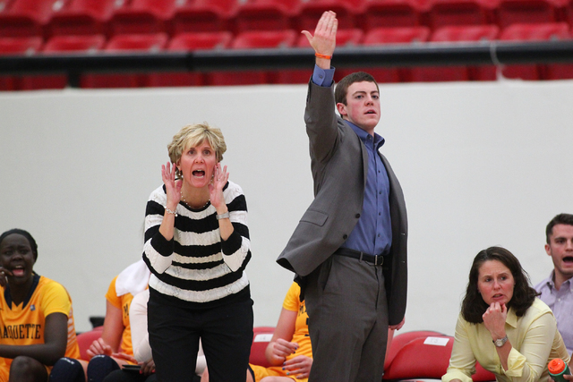 Marquette assistant coach Tyler Summitt, son of NCAA women's basketball coaching legend Pat Summitt, motions to players as head coach Terri Mitchell shouts to the team as the Golden Eagles take on ...
