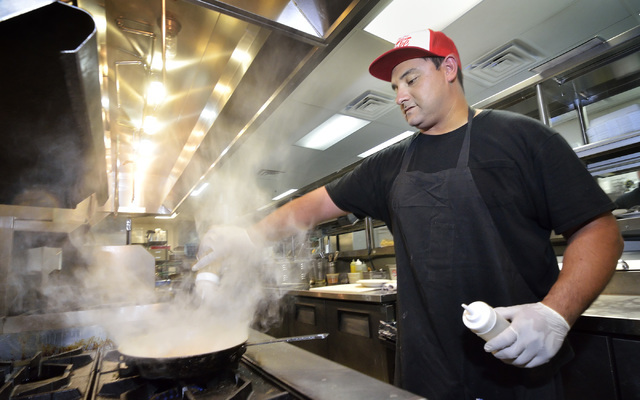 Sam Cruz works on a dish in the kitchen at McFadden's Restaurant and Saloon in Town Square at 6593 Las Vegas Blvd. South in Las Vegas on Saturday, June 4, 2016. Bill Hughes/Las Vegas Review-Journal
