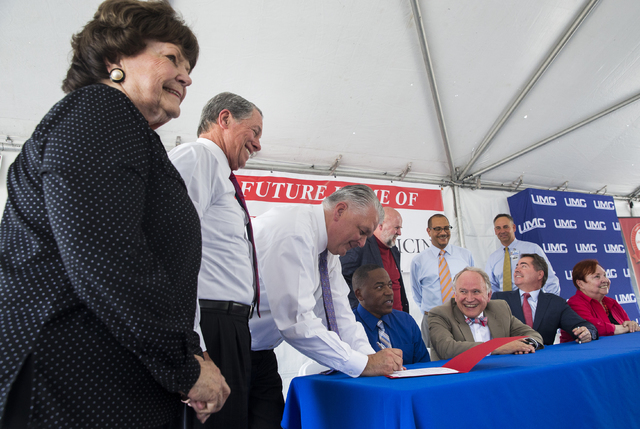 Las Vegas Councilwoman Lois Tarkanian, from left, University Medical Center Governing Board Chairman John O'Reilly and Clark County Commission Chairman Steve Sisolak take part in a ceremony to com ...