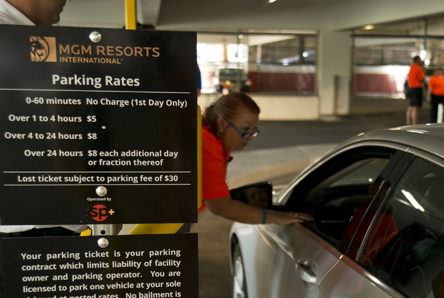 Viv Fasulo helps a customer enter the parking garage on the first day of paid parking at the Monte Carlo hotel-casino parking garage on the Las Vegas Strip on Monday, June 6, 2016. Daniel Clark/La ...