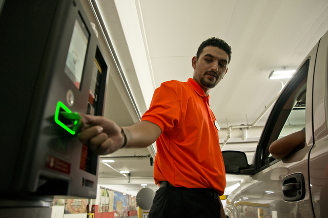 Rafael Lopez helps a visitor exit the parking garage on the first day of paid parking at the Monte Carlo hotel-casino parking garage on the Las Vegas Strip on Monday, June 6, 2016. Daniel Clark/La ...