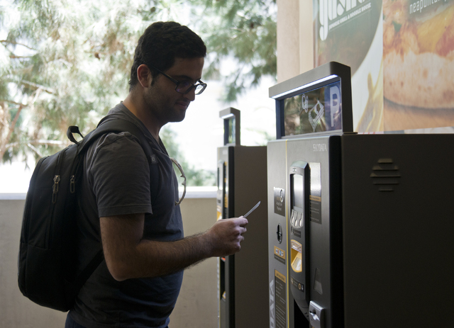 Bam Azizi uses a kiosk to pay for his parking on the first day of paid parking at the Monte Carlo hotel-casino parking garage on the Las Vegas Strip on Monday, June 6, 2016. Daniel Clark/Las Vegas ...