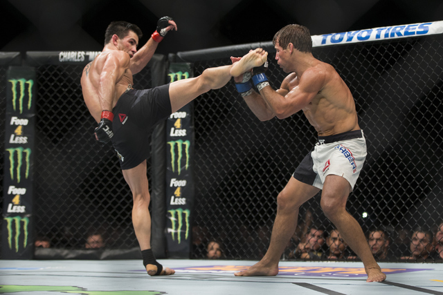 Dominick Cruz, left, throws a kick against Urijah Faber in the UFC 199 bantamweight title bout at The Forum on Saturday, June 4, 2016, in Inglewood, Calif. Cruz won by unanimous decision. Erik Ver ...