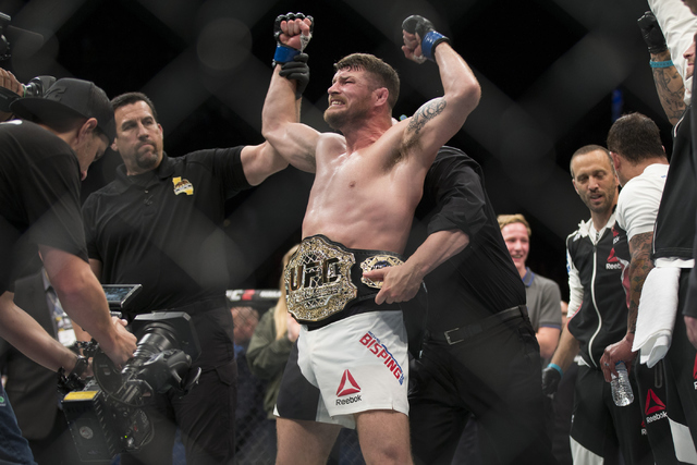 Michael Bisping celebrates his knockout win against Luke Rockhold in the first round of the UFC 199 middleweight title bout at The Forum on Saturday, June 4, 2016, in Inglewood, Calif. (Erik Verdu ...