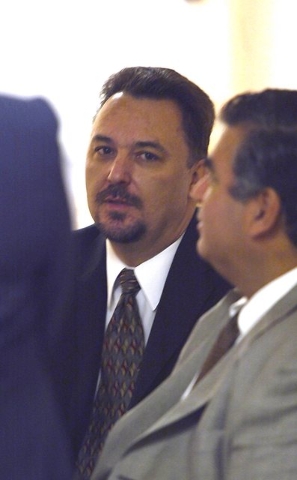 Tony Dane, center, waits in the hallway outside the state grand jury room in Las Vegas, Feb. 24, 2004, where the Moncrief election fraud hearing is being held. Attorney Don Chairez is seated at ri ...