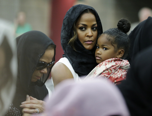 Muhammad Ali's wife Lonnie and her daughter Laila attend Muhammad Ali's Jenazah, a traditional Islamic Muslim service, in Freedom Hall, Thursday, June 9, 2016, in Louisville, Ky. Laila is holding  ...