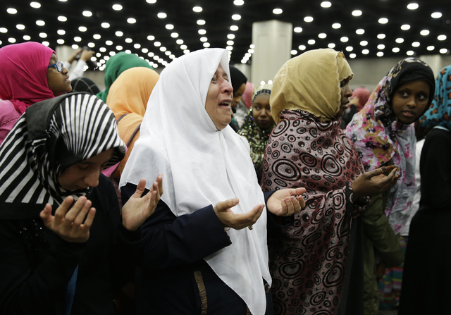 Muslim women pray before Muhammad Ali's Jenazah, a traditional Islamic Muslim service, in Freedom Hall, Thursday, June 9, 2016, in Louisville, Ky. (Darron Cummings/AP)