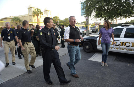 Orlando Mayor Buddy Dyer, second from right, and Orlando Police Chief John Mina arrive to a news conference after a fatal shooting at Pulse Orlando nightclub in Orlando, Fla., Sunday, June 12, 201 ...
