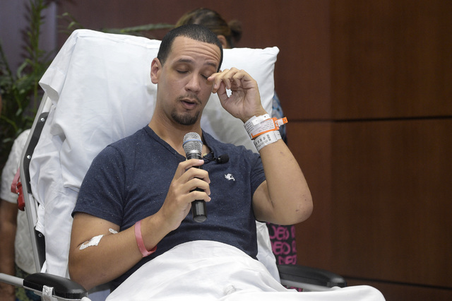 Angel Santiago, a victim in the Pulse nightclub shooting, wipes his eye as he relays his story during a news conference at Florida Hospital Orlando on June 14, 2016, in Orlando, Fla. (AP Photo/Phe ...