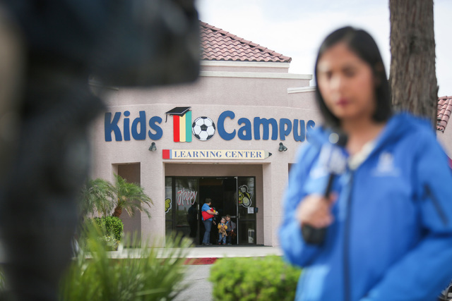 A family walks out of Kids Campus daycare as a TV reporter gives a live report in North Las Vegas on Friday, May 6, 2016. On Thursday, police say Travis Spitler shot and killed his ex-girlfriend C ...
