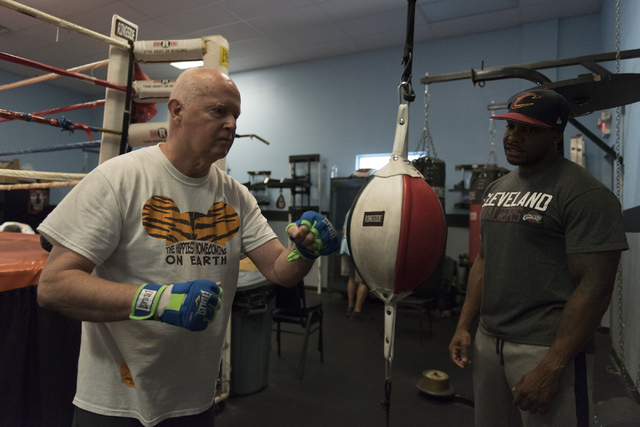 Robert Nicholson, left, punches a speed bag as instructor Donche King gives guidance during the Rock Steady Boxing Program at Richard Steele Boxing Club in North Las Vegas June 20, 2016. Jason Ogu ...