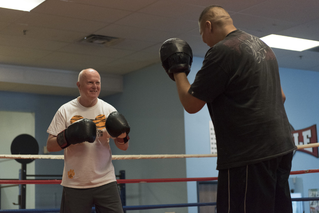 Robert Nicholson, left, does punching exercises with instructor Alvaro Morales during the Rock Steady Boxing Program at Richard Steele Boxing Club in North Las Vegas June 20, 2016. Jason Ogulnik/View