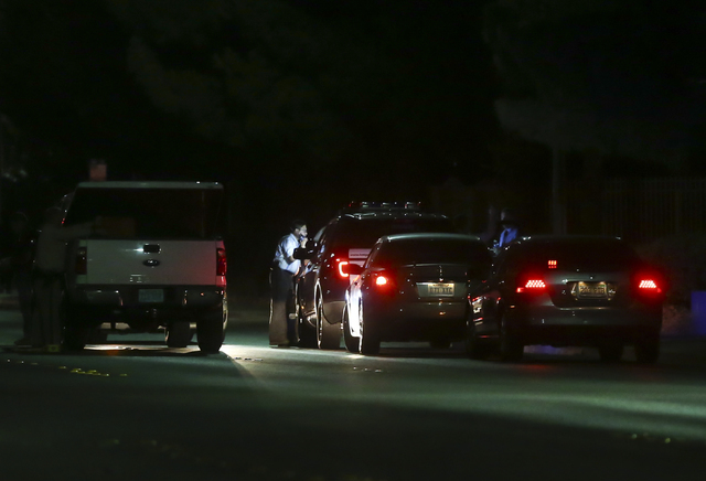Las Vegas police block off Torrey Pines Drive near Lake Mead Boulevard as a barricade situation goes on in a nearby apartment complex in Las Vegas on Wednesday, June 29, 2016. A homicide occurred  ...
