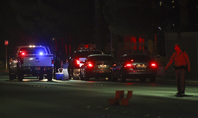 Las Vegas police block off Torrey Pines Drive near Lake Mead Boulevard as a barricade situation goes on in a nearby apartment complex in Las Vegas on Wednesday, June 29, 2016. A homicide occurred  ...