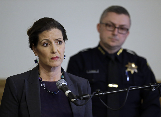 Oakland Mayor Libby Schaaf, left, speaks beside Oakland Chief of Police Sean Whent in Oakland, Calif., in May. (Ben Margot/The Associated Press)