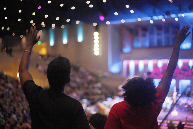 Audience members worship during a music performance at a service to honor victims of the Orlando nightclub shooting at the First Baptist Orlando Church in Orlando, Florida on Tuesday, June 14, 201 ...