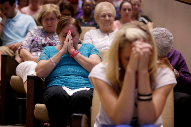 Letty Soto, back, and Diane Clarke Jack, front, pray at a service to honor victims of the Orlando nightclub shooting at the First Baptist Orlando Church in Orlando, Florida on Tuesday, June 14, 20 ...