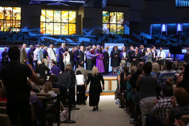 Community and religious leaders gather on stage and invite LGBTQ members of the audience to join them to pray at a service to honor victims of the Orlando nightclub shooting at the First Baptist O ...