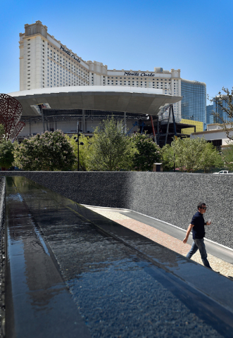 The Monte Carlo hotel-casino is seen reflected in a water feature at The Park Friday, June 3, 2016, in Las Vegas. MGM Resorts International announced the Monte Carlo will be transformed into two h ...