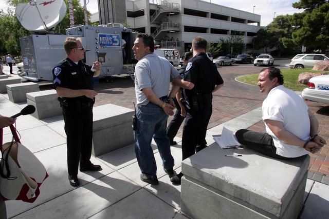 Republican activist Tony Dane, left, and another petition signature gatherer are arrested on the UNLV campus outside a rally attended by First Lady Laura Bush Tuesday, May 18, 2004. (K.M. Cannon/L ...