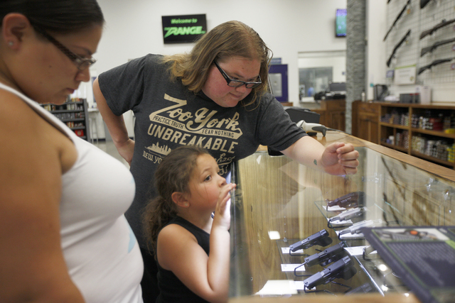 Naomi Ramirez-Lang, from left, her wife Kimberly, and their daughter Carolina Ramirez look at guns at The Range 702 store in Las Vegas on Monday, June 20, 2016. Rachel Aston/Las Vegas Review-Journ ...