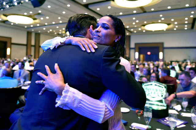 Biaggio Ali Walsh, left, receives a hug from his mother, Rasheda Ali Walsh after receiving his football award at the Best of Nevada Preps awards banquet at the Red Rock hotel-casino Saturday, June ...