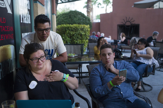 Staff members including campaign manager Antonio Valdovinos, right, react as early results show Democratic Congressional District 4 candidate Lucy Flores trailing in second place behind Ruben Kihu ...