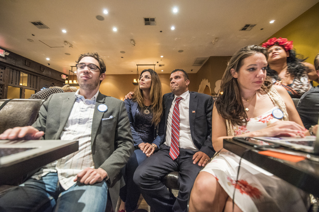 Steven Conger Jr., assistant campaign manager, from left, Sameera Sbaih, Democratic Congressional District 3 candidate Jesse Sbaih, and campaign manager Angie Morelli look at election results duri ...