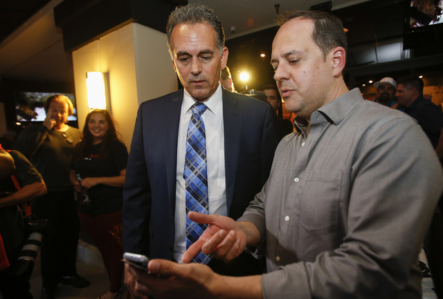 Republican Congressional District 3 candidate Danny Tarkanian, left, looks at campaign results with Jamie Fisfis during his election night gathering at Born and Raised in Las Vegas on Tuesday, Jun ...
