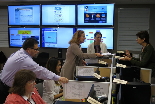 In this Feb. 24, 2016 file photo, workers from the Puerto Rico Health Department and the Centers for Disease Control and Prevention review Zika-related data collected by the island's health depart ...