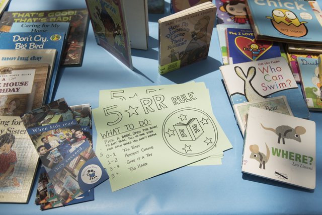 A card explaining the 5 star Reading Rangers rule sits on a table with books that are given away as prizes for completing activities during the Clark County School District's Reading Rangers progr ...