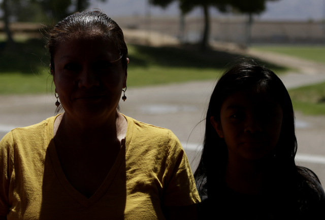 Francisca Sanchez, 41, left, and her daughter Karla Ortiz, 11, who don't want to show their face, are photographed during an interview at Nellis Meadows Park on Thursday, June 9, 2016, in Las Vega ...